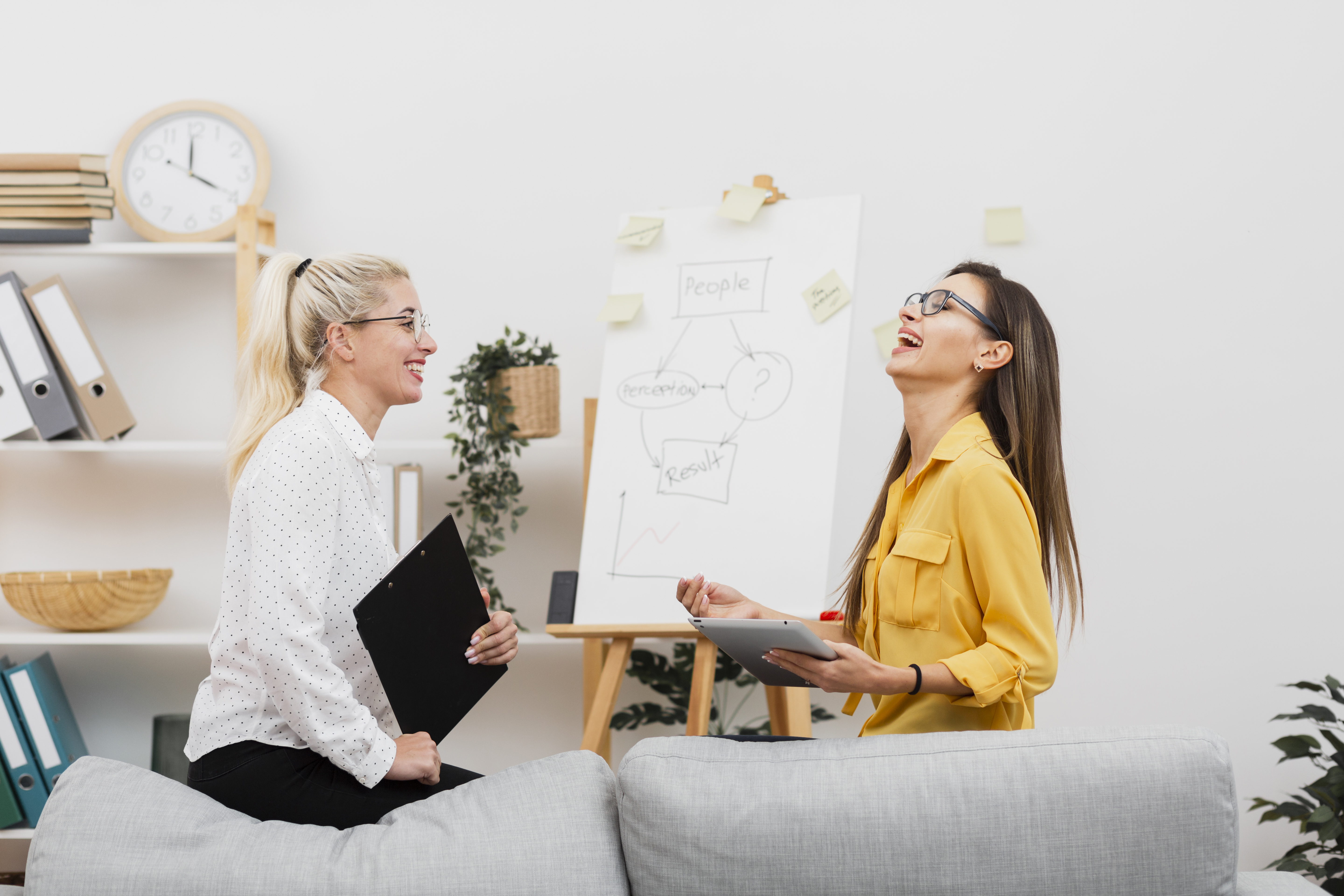 lateral-view-smiling-women-holding-tablet-clipboard